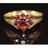 A 9ct gold ring set with garnets in a cluster, 2.2g, size O