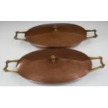 WAS Benson Arts & Crafts pair of twin handled copper and brass covered dishes, length 32cm