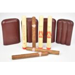 Three Monte Cristo cigars in metal cedarwood lined tubes, together with two Cuban Crafters leather