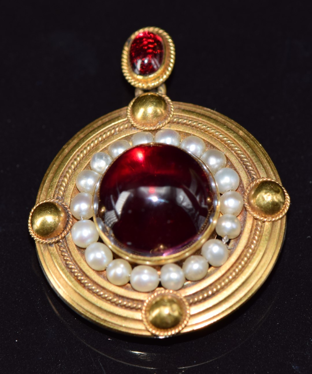 Victorian yellow metal pendant / brooch set with two foiled garnet cabochons surrounded by natural