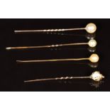 Four 9ct gold stick pins each set with a pearl, 4g