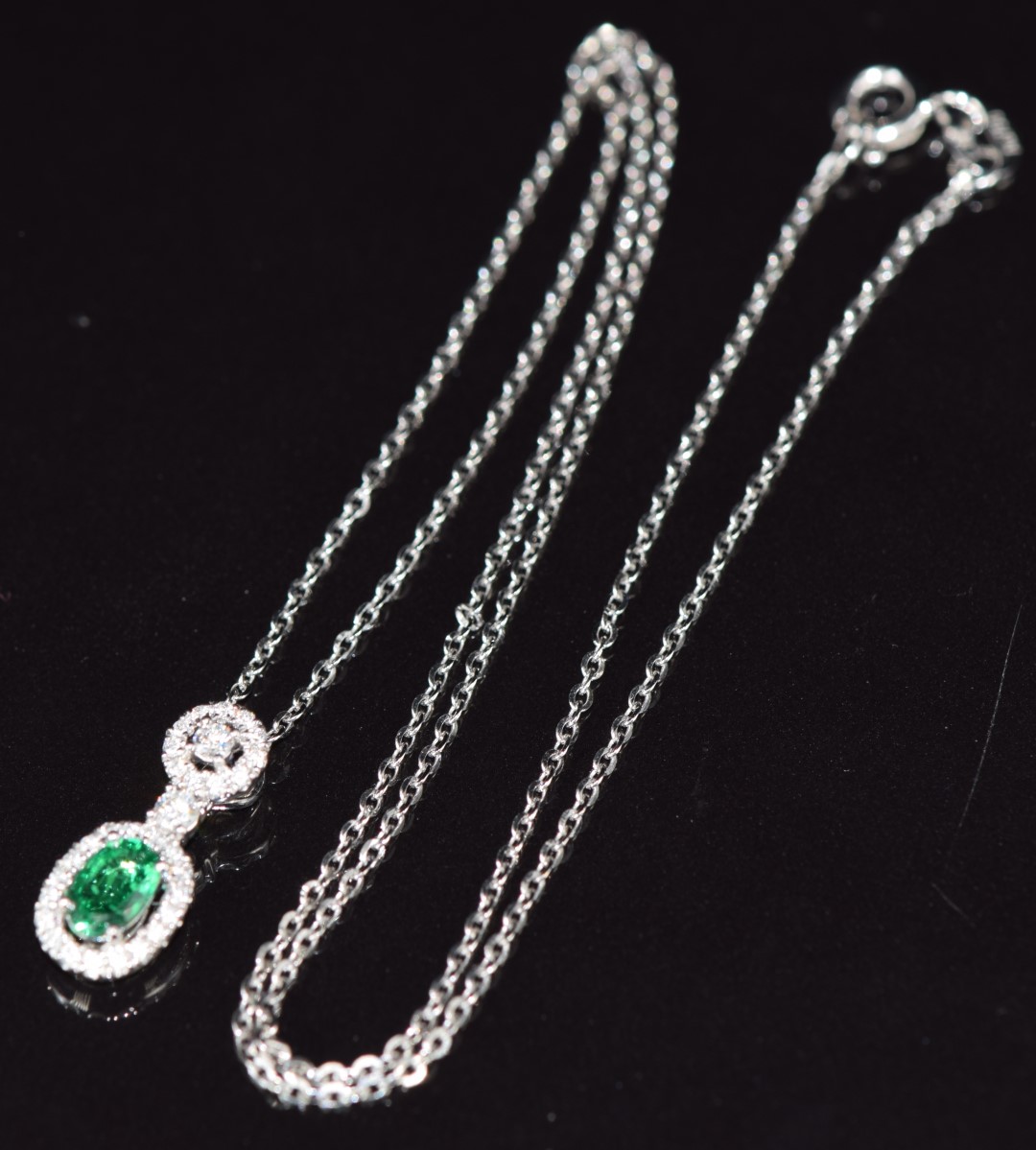 An 18ct white gold pendant set with an oval cut emerald of approximately 0.5ct surrounded by - Image 3 of 3