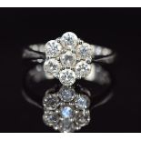 An 18ct white gold ring set with seven diamonds in a cluster, each diamond approximately 0.15ct, 4.