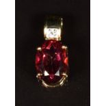 A 14k gold pendant set with red and white topaz, 3.6g