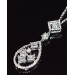 An 18ct white gold pendant set with four princess cut diamonds and further round brilliant cut
