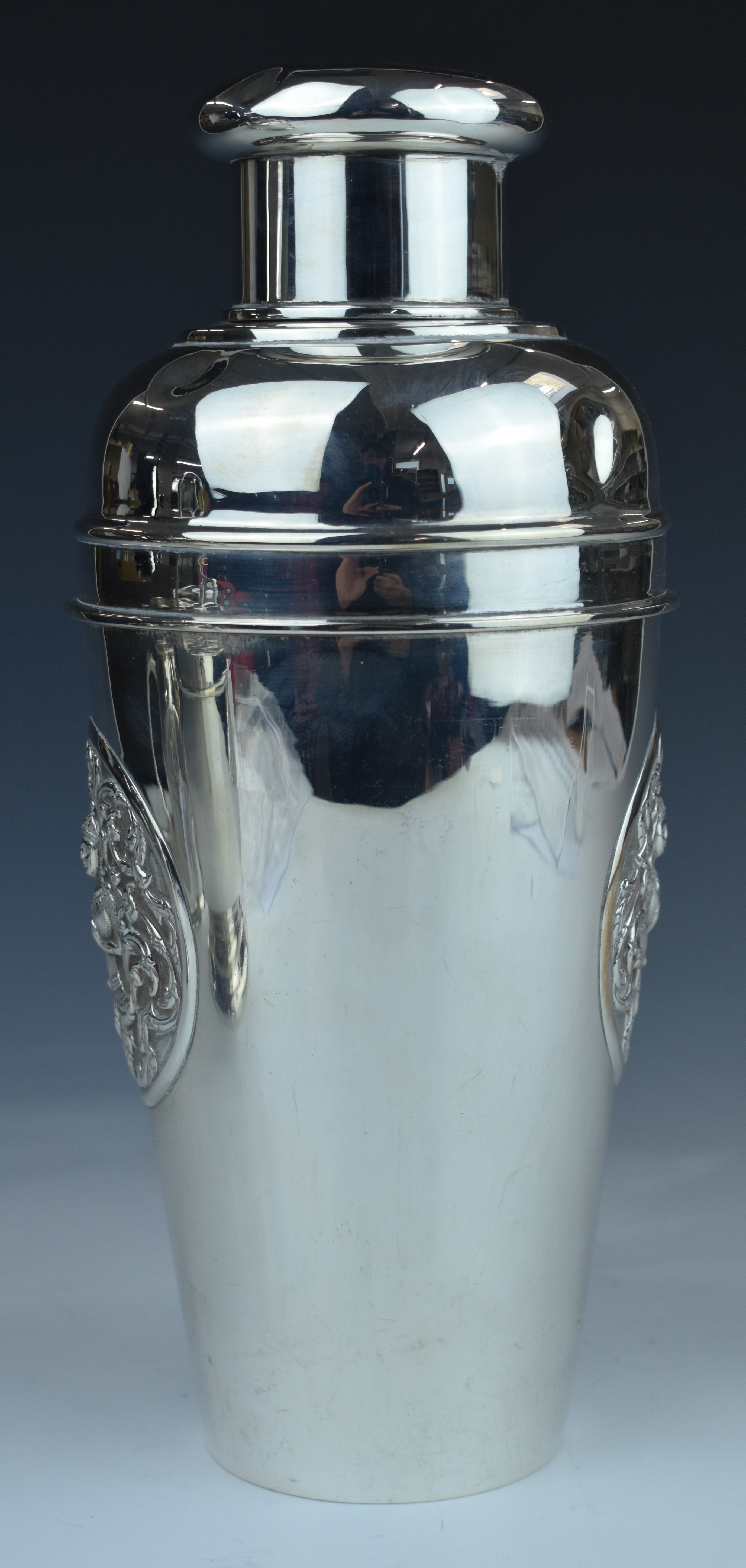 Thai silver cocktail shaker with embossed decoration of a deity to front and back, marked to base