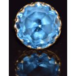 An 18k gold ring set with a round cut topaz, 8.5g, size L