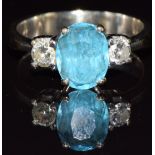 An 18k white gold ring set with an oval cut topaz and two diamonds, each approximately 0.15ct