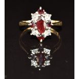 A 9ct gold ring set with a marquise and round cut garnets and diamonds, 3.1g, size N
