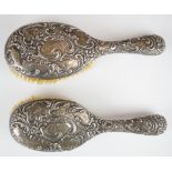 Pair of Victorian hallmarked silver brushes with embossed decoration, Birmingham 1895, maker Henry