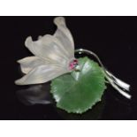 A 14k white gold brooch in the form of a lily set with nephrite jade, quartz, rubies and a