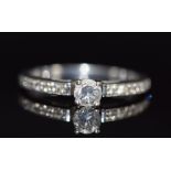 An 18ct white gold ring set with a diamond of approximately 0.2ct with diamond encrusted