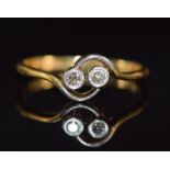 An 18ct gold ring set with two diamonds in a platinum twist setting, 2.0g, size I/J