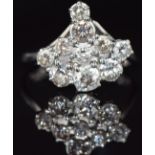 An 18ct white gold ring set with a cluster of old cut diamonds, largest 0.28ct, 4.6g, size N
