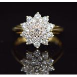 An 18ct gold ring set with diamonds in a cluster, 4.6g, size M