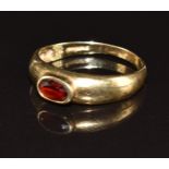A 9ct gold ring set with an oval cut garnet, 2.6g, size P