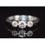 A platinum ring set with three diamonds, the centre diamond approximately 0.3ct, 4.4g, size L
