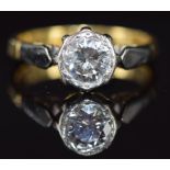 An 18ct gold ring set with a 0.8ct round cut diamond in a platinum setting, 3.4g, size J