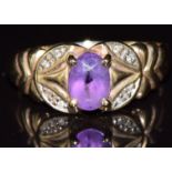 A 9ct gold ring set with an oval cut amethyst and diamonds, 2.3g, size P