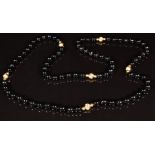 A beaded onyx necklace interspersed with 9ct gold beads