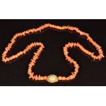 A beaded 19thC coral necklace with yellow metal clasp