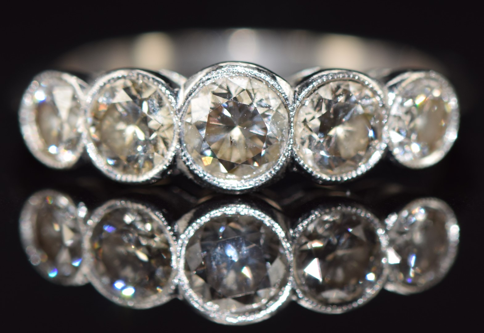 An 18ct white gold ring set with five diamonds, the centre diamond approximately 0.42ct, total