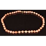 A beaded coral necklace with 18ct gold clasp and beads