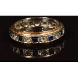 A 9ct gold eternity ring set with sapphires and paste. 3.2g