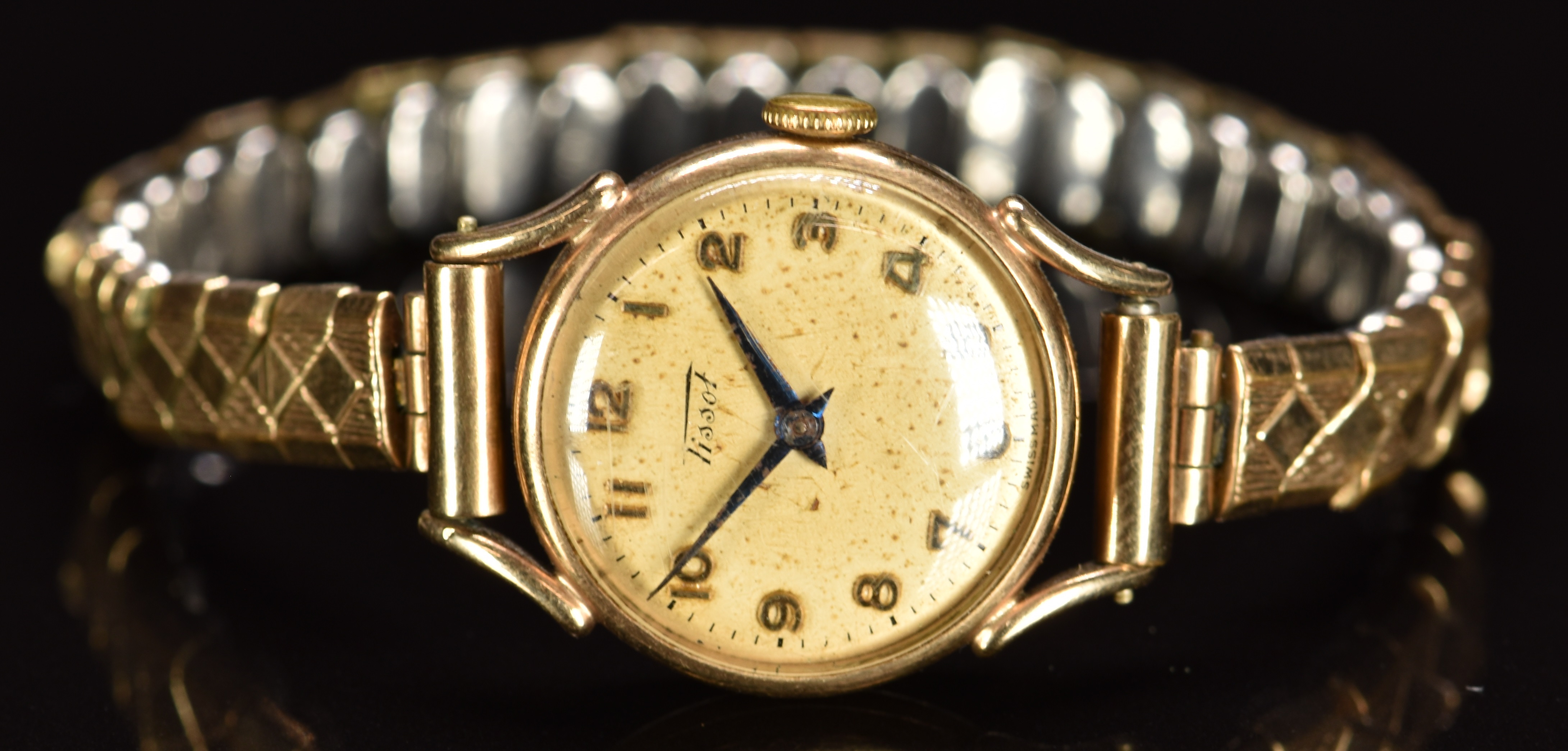 Tissot 9ct gold ladies wristwatch with blued hands, gold Arabic numerals, silver dial and signed