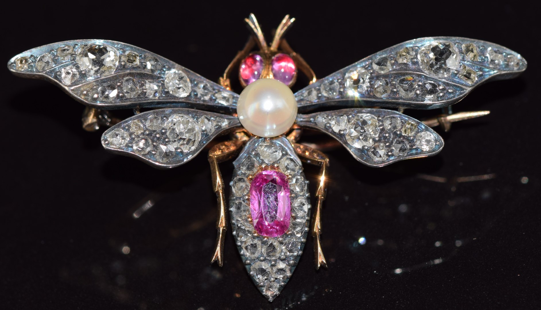 A c1880 gold and silver brooch in the form of a fly set with a natural pearl, pink sapphires, old