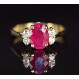 A 14k gold ring set with an oval cut ruby and four diamonds, 3.4g, size O