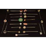 Fifteen Victorian stick pins including paste set, knot design, horseshoe and shield and six other