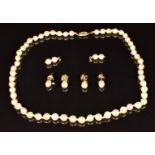 A cultured pearl necklace with 14k gold clasp and two pairs of 9ct gold and pearl earrings