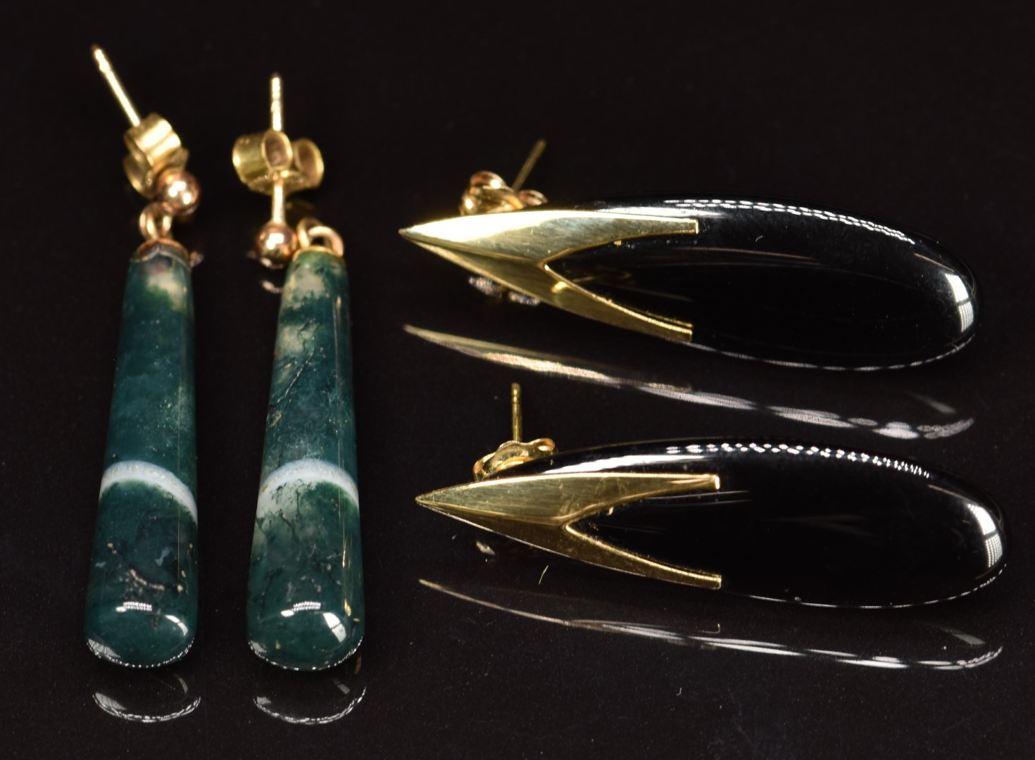 A pair of 14k gold earrings set with onyx and a pair of 9ct gold earrings set with moss agate