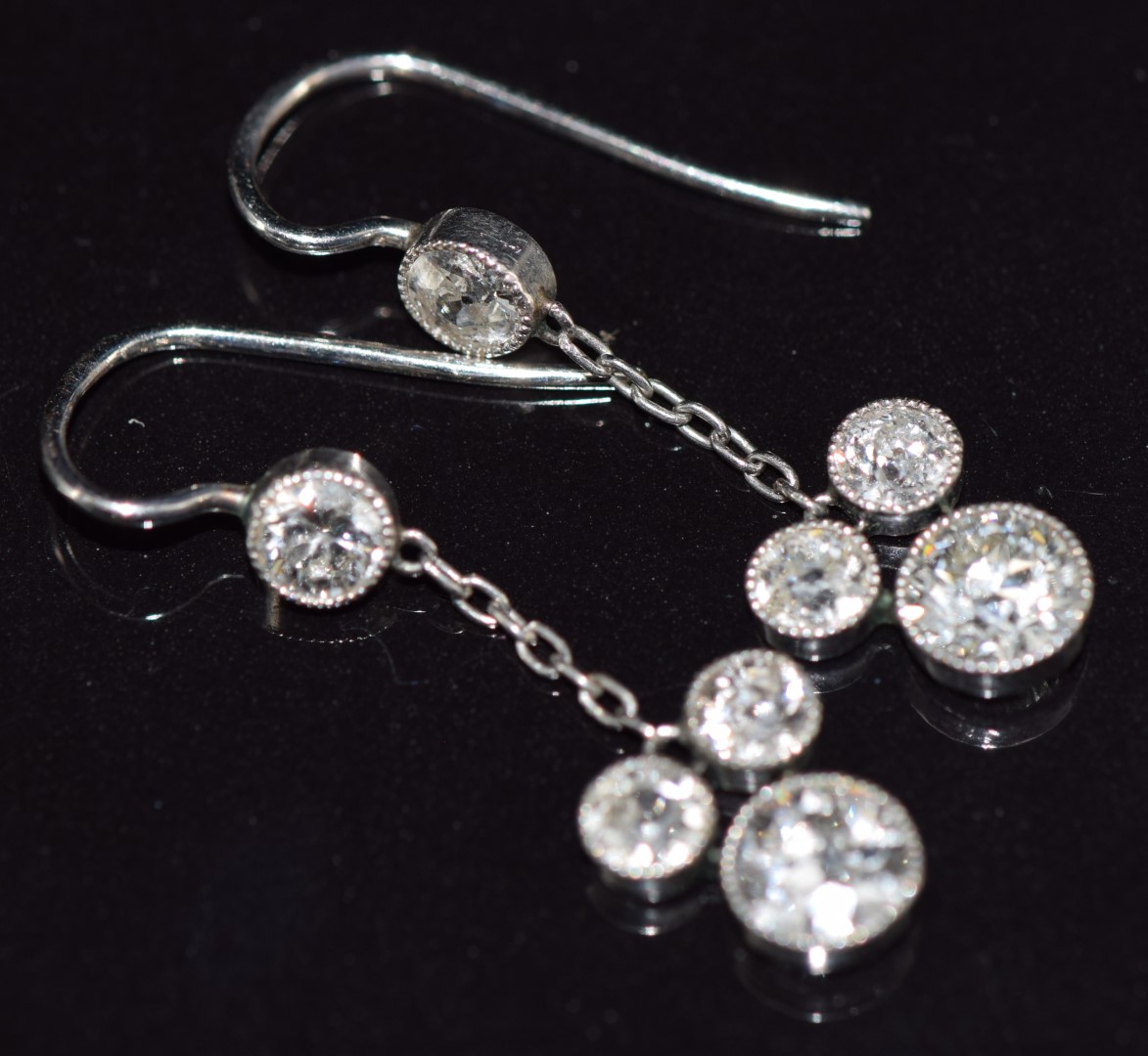 A pair of Art Deco platinum earrings, each set with transitional cut diamonds of approximately 0. - Image 2 of 3