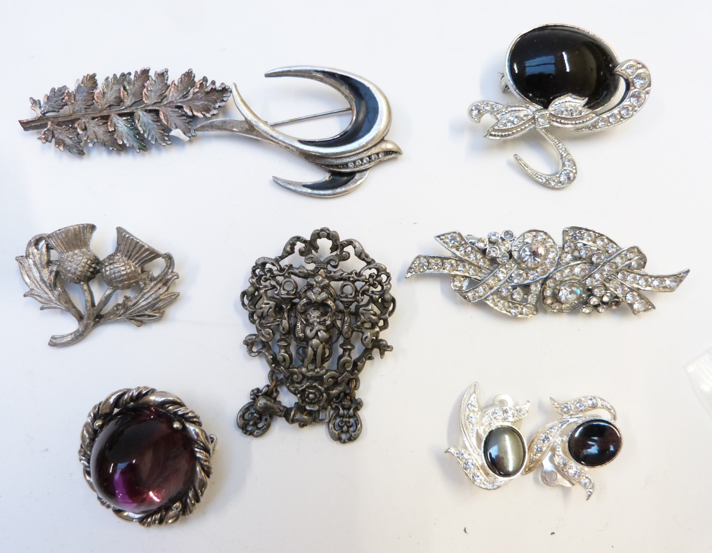 A collection of costume jewellery including two silver napkin rings, costume brooches, beads, - Image 3 of 9