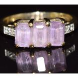 A 9ct gold ring set with three amethysts and topaz, 2.6g, size N