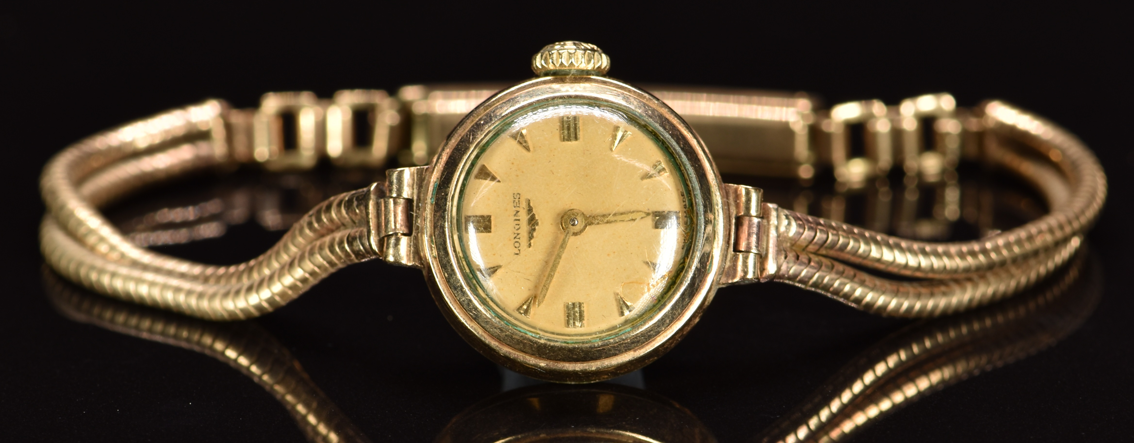 Longines 9ct gold ladies wristwatch with gold hands and hour markers, champagne dial and signed 17