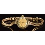 Longines 9ct gold ladies wristwatch with gold hands and hour markers, champagne dial and signed 17