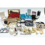 A collection of costume jewellery including silver locket, vintage brooches, boxed watches, £5 coin,