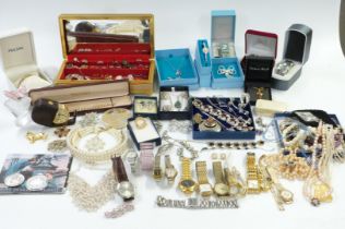 A collection of costume jewellery including silver locket, vintage brooches, boxed watches, £5 coin,