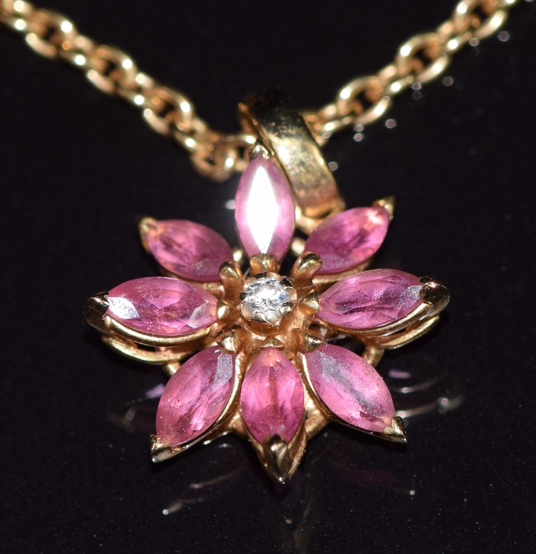 Asprey 18ct gold pendant set with a diamond surrounded by marquise cut pink tourmalines in a