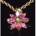 Asprey 18ct gold pendant set with a diamond surrounded by marquise cut pink tourmalines in a