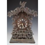 Late 19th or early 20thC mantel or bracket cuckoo clock with carved leaf borders and pediment,