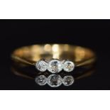 An 18ct gold ring set with three diamonds in a platinum setting, 2.3g, size P