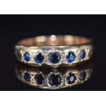 A 9ct gold ring set with five sapphires in star settings, 2.8g, size L/M