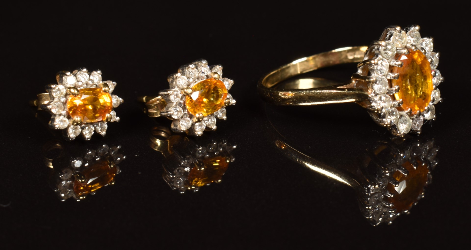 A 9k gold ring set with an oval cut orange sapphire surrounded by diamonds (size Q), with matching - Image 2 of 2