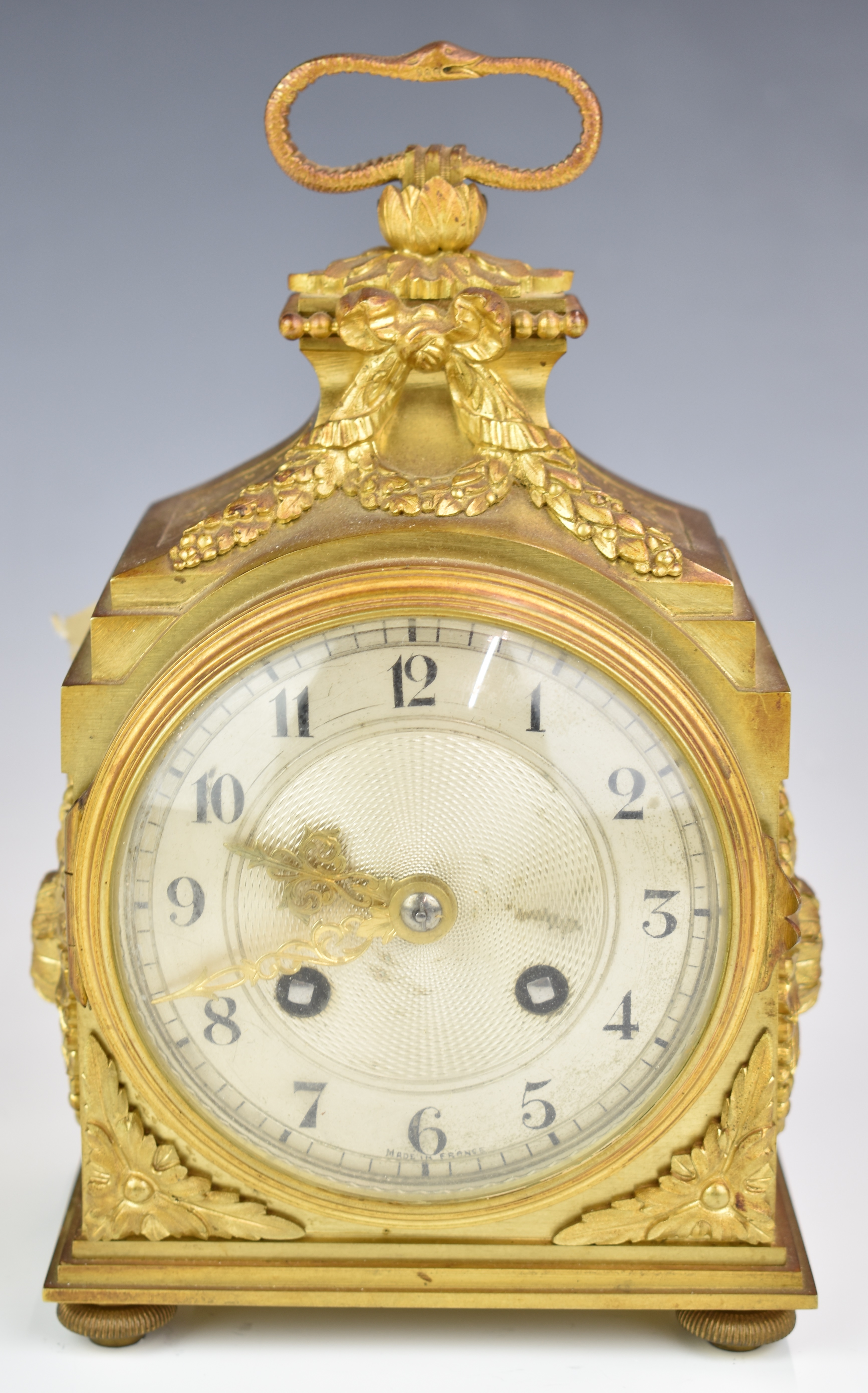 Gilt metal cased mantel or bracket clock with silvered dial, the French movement with platform