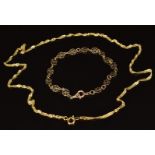 A 9ct gold necklace made up of twisted interlocking links and a 9ct gold bracelet made up of pierced