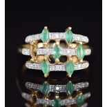 An 18k gold ring set with six marquise cut emeralds and diamonds (one emerald missing), 5.1g, size